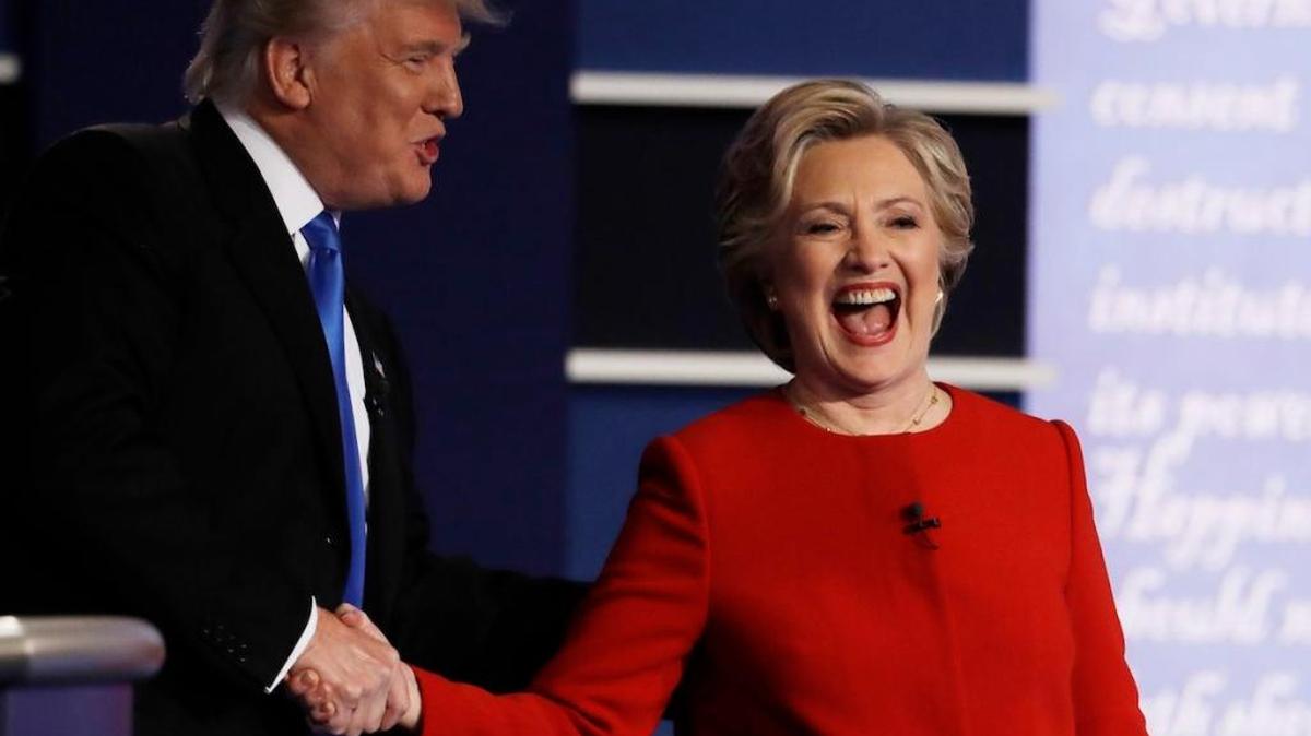 Democratic presidential nominee Hillary Clinton laughs with Republican presidential nominee Donald Trump following their presidential debate at Hofstra University in Hempstead, N.Y., Monday, Sept. 26, 2016.