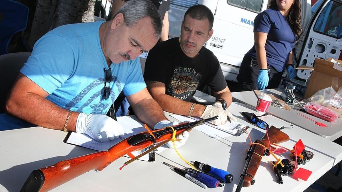 Miami Police detectives register guns collected from the public during a gun buy back event hosted by the department and the Rickia Isaac Foundation at Dorsey Park in Miami, December 17, 2016.