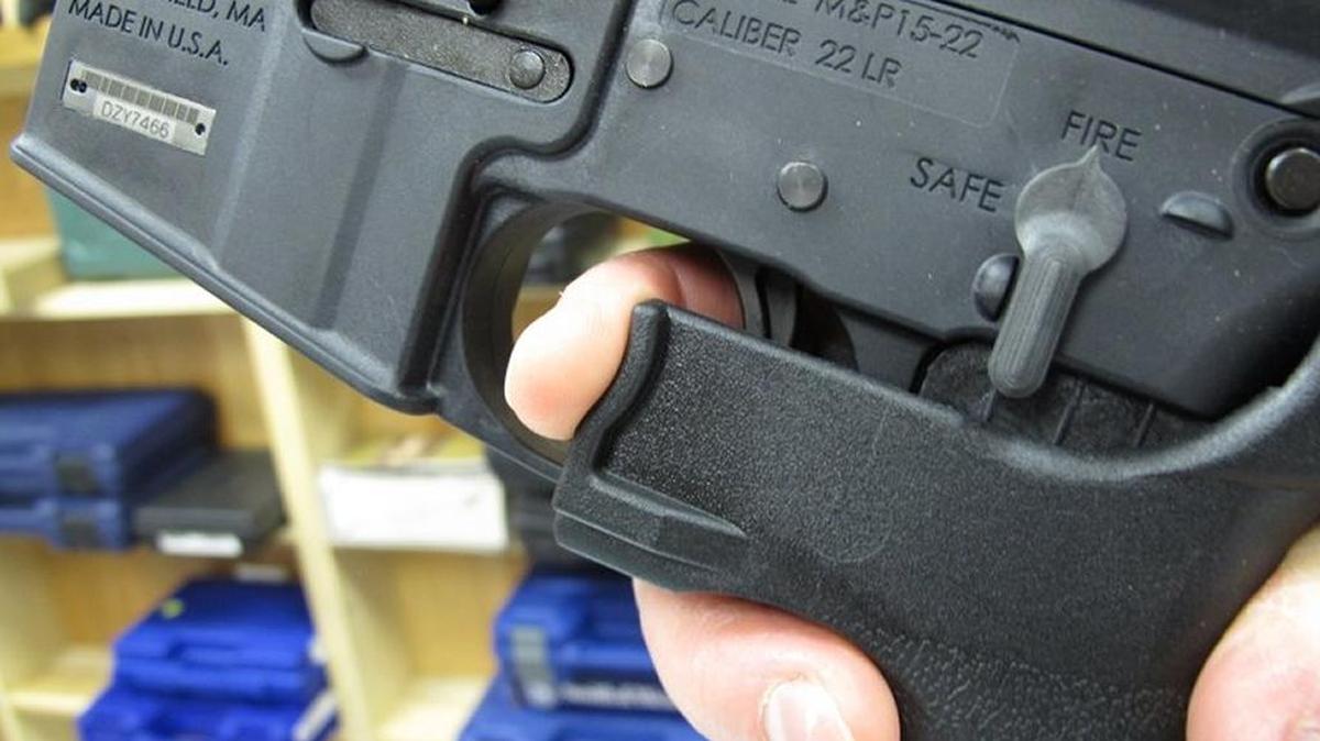 In this Feb. 1, 2013, file photo, an employee of North Raleigh Guns demonstrates how a “bump” stock works at the Raleigh, N.C., shop.