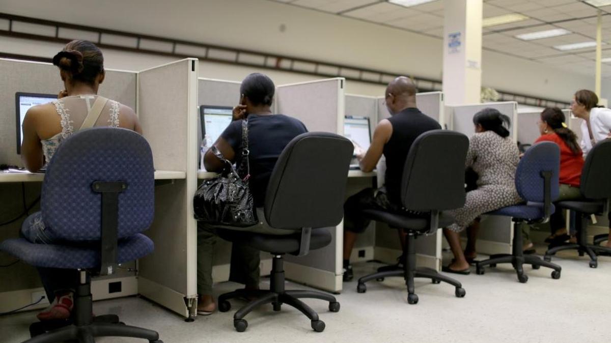 People look for job opportunities on the computers at CareerSource Florida on August 1, 2014 in Miami. The requirement proposed by the Florida House can be met by being employed or taking part in job training and preparation with CareerSource Florida, a quasi-private agency that connects businesses to potential employees.