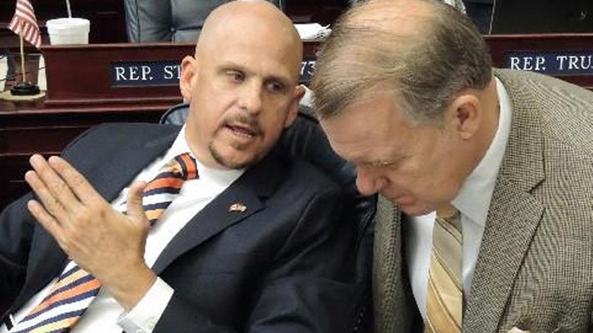 Former state Rep. Ritch Workman, R-Melbourne, speaks with former Rep. Doug Broxson, R-Midway, during a debate on the House floor in 2013.