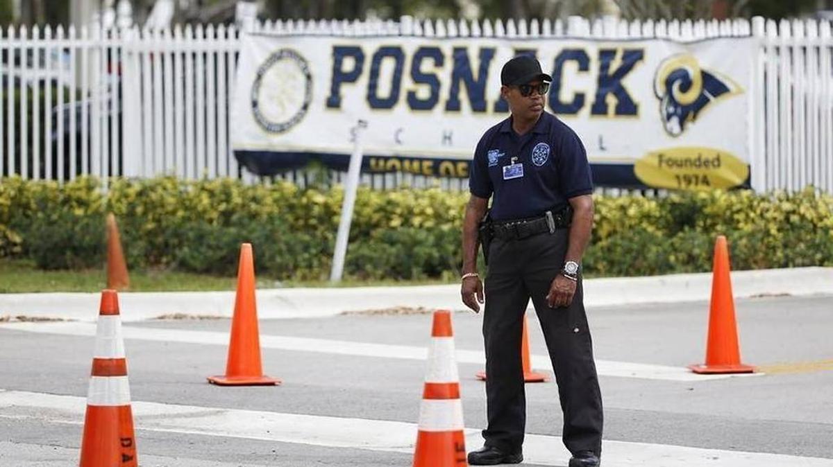 A security guard stands outside the entrance to the David Posnack Jewish Community Center and David Posnack Jewish Day School after people were evacuated because of a bomb threat, Monday, Feb. 27, 2017, in Davie, Fla. Jewish centers and schools across the nation are coping with another wave of bomb threats as officials in Philadelphia begin raising money to repair and restore hundreds of vandalized headstones at a Jewish cemetery.