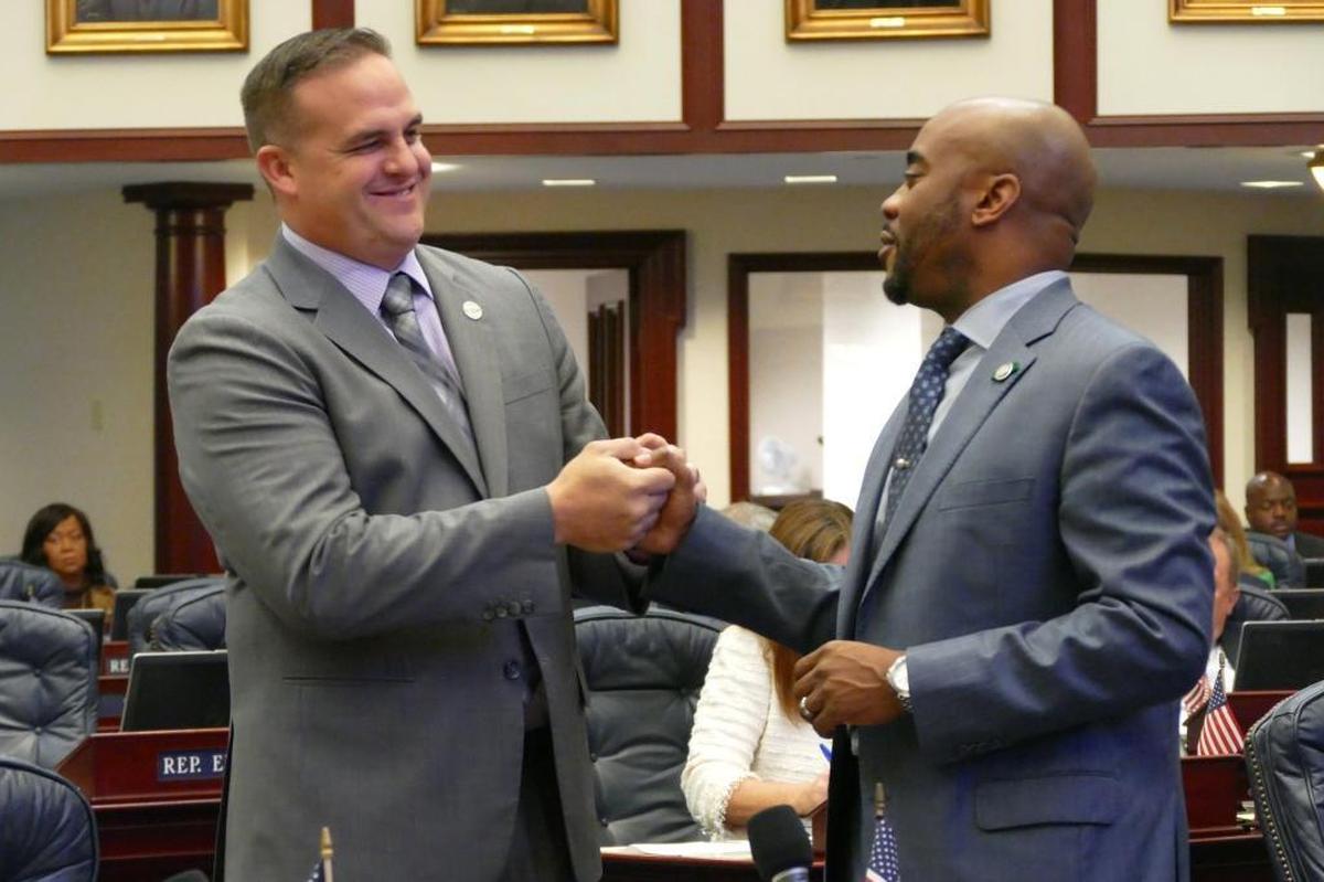 Then-Rep. Frank Artiles, R-Miami, is congratulated by Rep. Alan Williams, D- Tallahassee, after Artiles’ bill to repeal red light cameras passed the Florida House in the 2016 session. A similar bill he’d filed for 2017 was one of many pulled from the Senate after Artiles resigned.