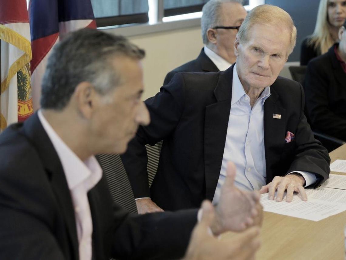 Sen. Bill Nelson listens to state Rep. Robert Asencio during a roundtable meeting in Miami in October.