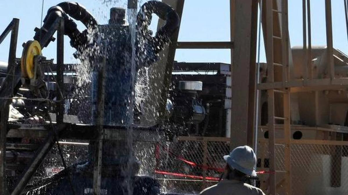 Water gushes out of a drilling pipe as it is pulled up to be replaced with a fresh pipe at a hydraulic fracturing site in Midland, Texas, Sept. 24, 2013. The drilling method known as fracking uses huge amounts of high-pressure, chemical-laced water to free oil and natural gas trapped deep in underground rocks.