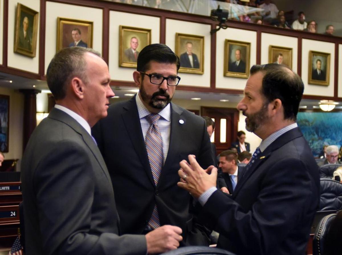 From the left, Speaker Richard Corcoran, R-Land O’Lakes, Rep. Manny Diaz, Jr., R-Hialeah, and Rep. Michael Bileca, R-Miami, talk on the House floor March 22, 2017. Diaz and Bileca were lead negotiators in crafting the final version of HB 7069, which was a top legislative priority of Corcoran’s.