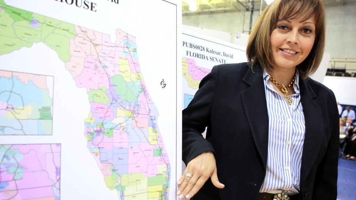 Margaret Delmont looks over a congressional district map during a redistricting hearing at Broward College on August 16, 2011.