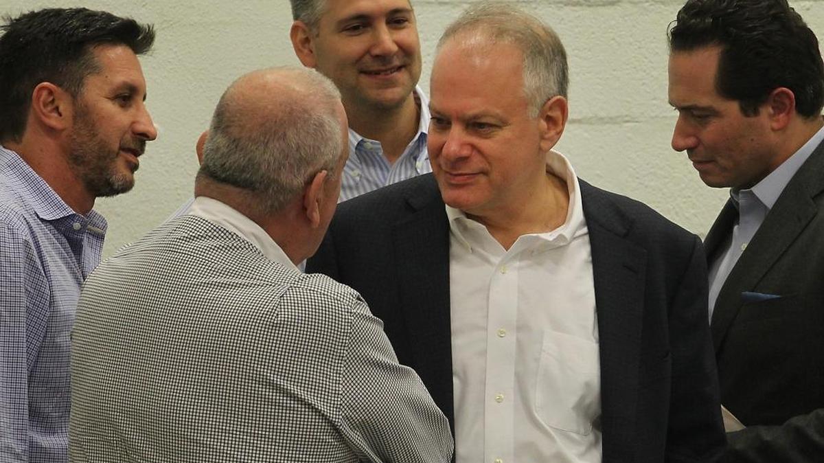 Stephen Bittel, center, chats with voters as members of the Miami-Dade Democratic Party Executive Committee in Wynwood in December.