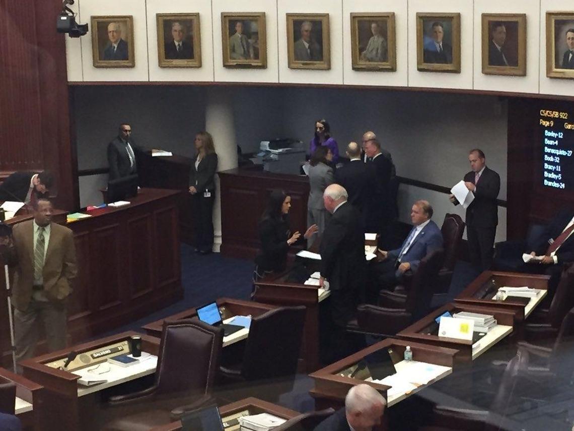 Miami Republican Sen. Anitere Flores spoke with Tallahassee Democratic Sen. Bill Montford at his desk on the Senate floor, when Flores’ testing reform bill, SB 926, was “temporarily postponed” Wednesday morning. Montford said earlier in the day he was “frustrated” by the bill.