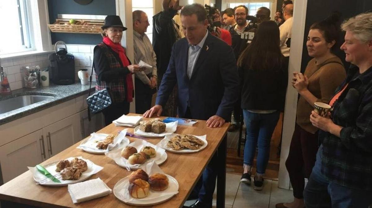 Philip Levine looks over the spread laid out for his arrival at Tiffany Parisi’s Riverside home in Jacksonville during his statewide bus tour.