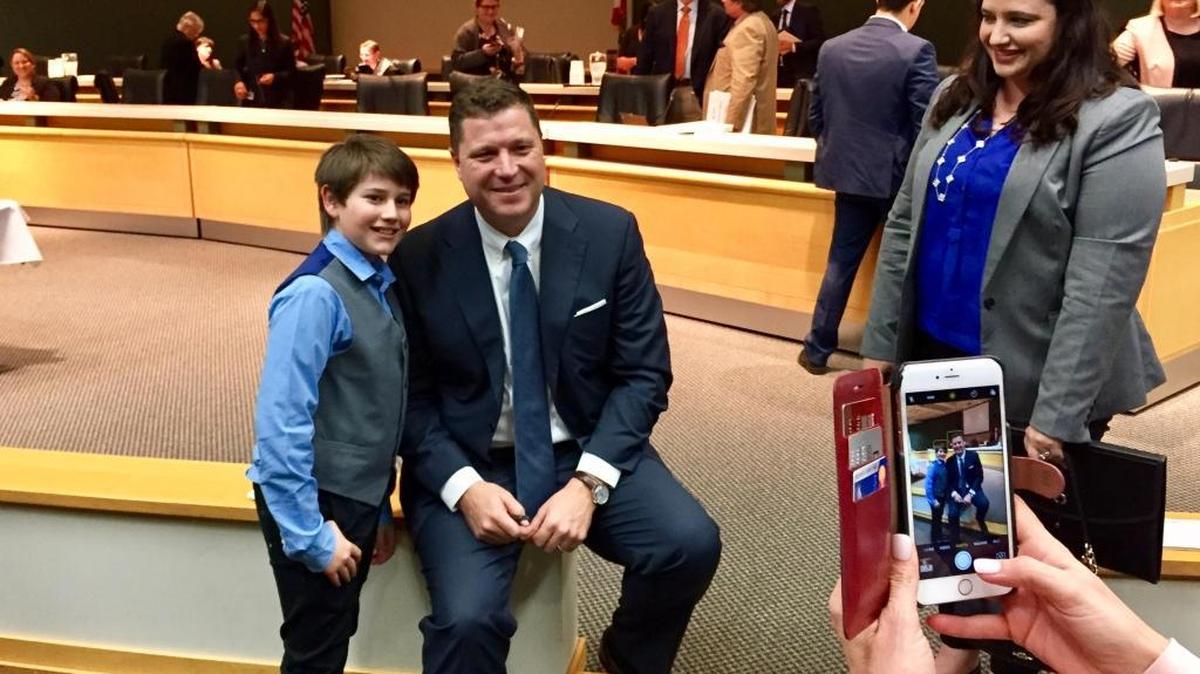 Ethan Greenberg, a sixth-grader at Silver Trail Middle School in Pembroke Pines, poses for a photo with state Sen. Jeff Brandes, R-St. Petersburg, while his mom, Ryan, looks on after a Senate Education Committee meeting Monday in Tallahassee. Ethan and Ryan Greenberg spoke in favor of Brandes’ proposal to make computer coding count as a foreign language for Florida high school students.