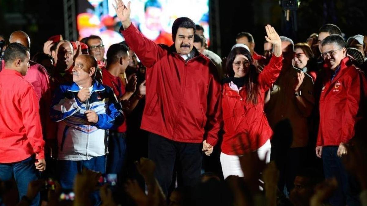 Venezuelan President Nicolas Maduro and his wife, Cilia Flores, wave next to electoral candidates after the first results of the controversial election for a constituent assembly on July 31, 2017, on the Bolivar square in Caracas. Florida officials announced they will continue to refrain from allowing the state to invest in Maduro-controlled companies.