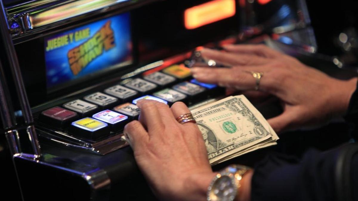 A patron plays a slot machine at the Magic City Casino in Miami.