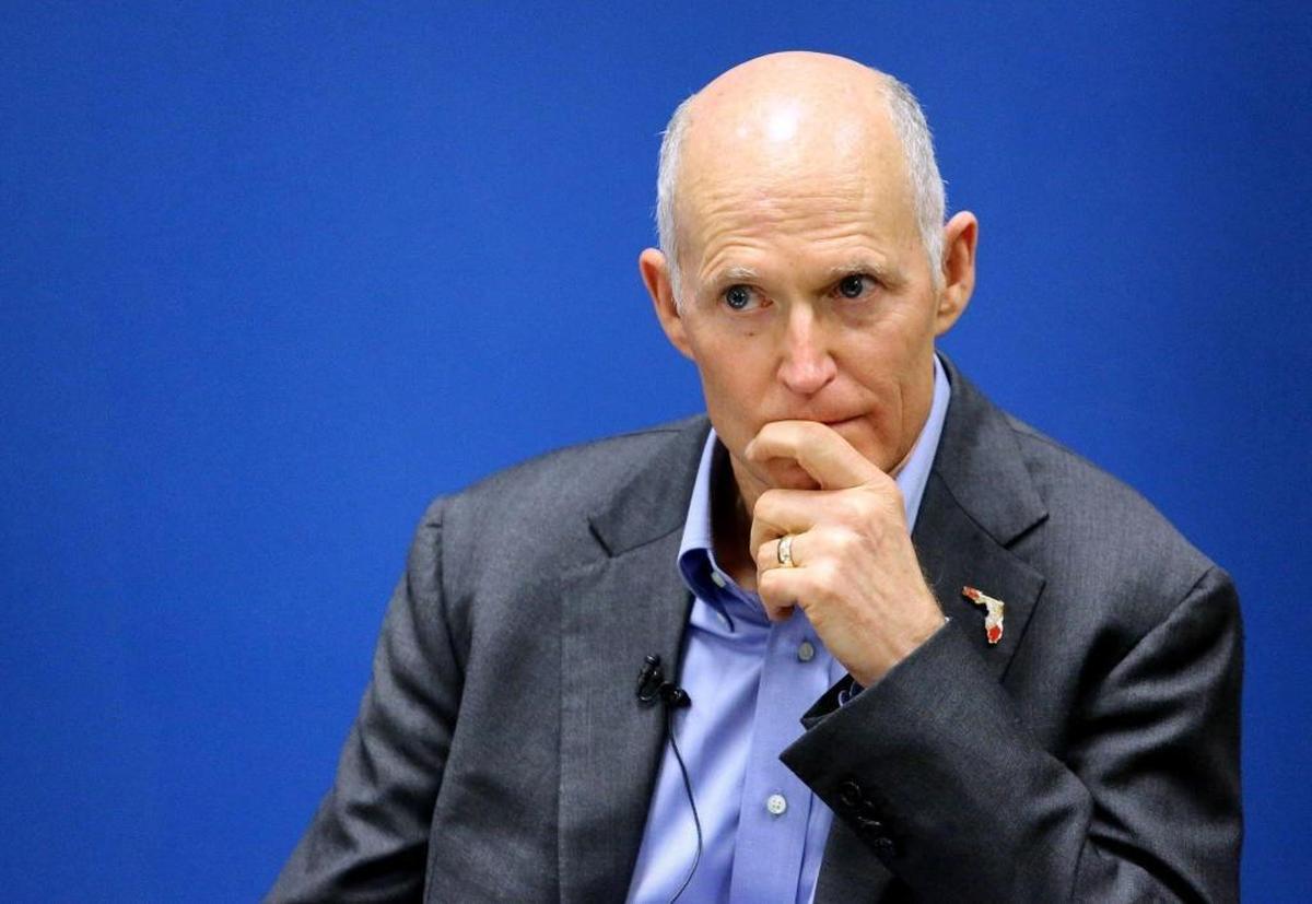 Gov. Rick Scott listens during a roundtable discussion in Kissimmee in November about the influx to the Orlando area of Puerto Rico residents affected by Hurricane Maria.