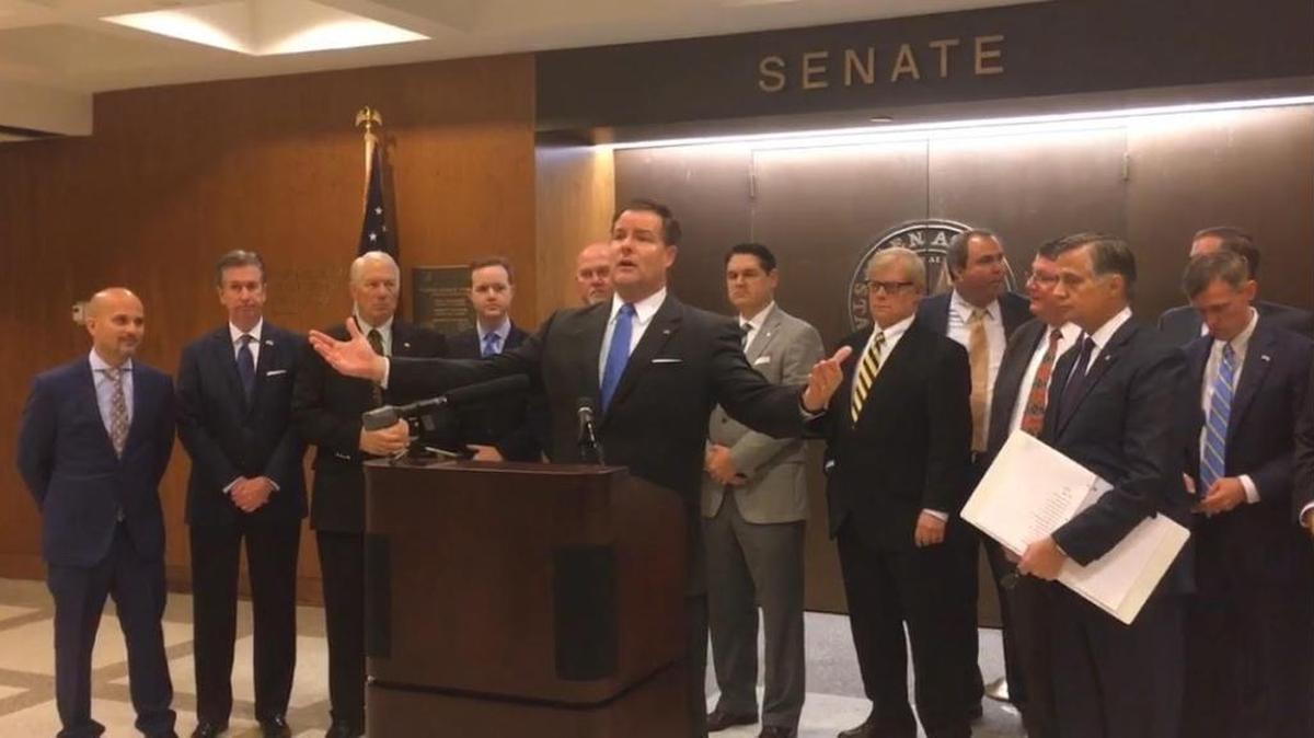 State Sen. Aaron Bean, R-Fernandina Beach, unveils a proposal to ban “sanctuary cities” in Florida during a press conference Wednesday at the Florida Capitol in Tallahassee