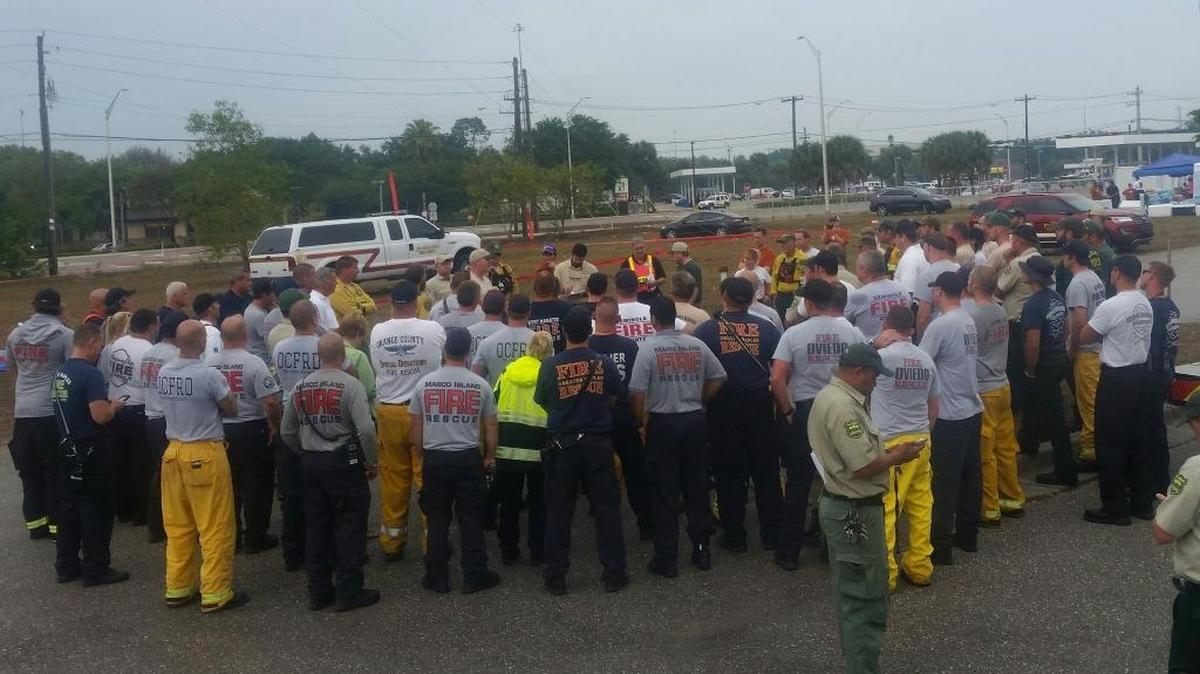 Firefighters coming onto the night shift in Collier County are briefed on the fire.