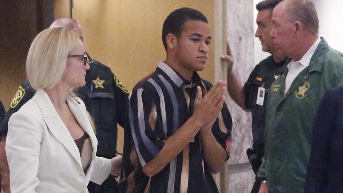 The brother of Nikolas Cruz, Zachary Cruz, center, leaves the courtroom after his brother's arraignment before Broward Circuit Judge Elizabeth Scherer, Wednesday, March 14, 2018, in Fort Lauderdale. The Broward Sheriff’s Office arrested Zachary Cruz Monday, March 19, 2018, and charged him with trespassing at Marjory Stoneman Douglas High School, the scene of last month’s mass shooting by his brother Nikolas.
