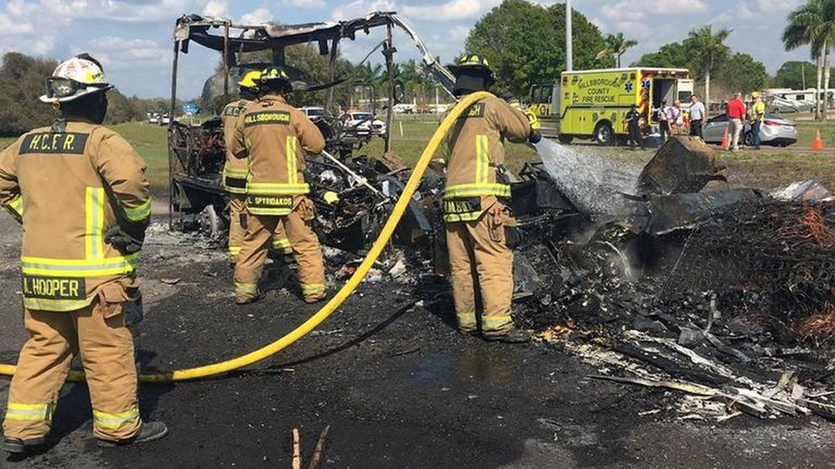 Firefighters work to put out a a fire that fully engulfed an RV on Interstate 75 in Hillsborough County Tuesday.