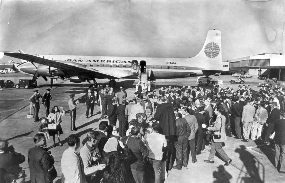 Cuban refugees onboard the first Freedom Flight arrive at Miami International Airport on Dec. 1, 1965, to a sea of relatives and reporters awaiting the historic flight.