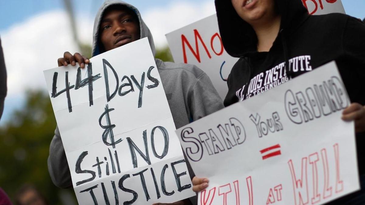 FILE PHOTO: David Frederick, left, and other supporters of Trayvon Martin gather April 9, 2012, for a rally in front of U.S. Sen. Marco Rubio's (R-FL) Miami office to ask him to retract his support for the state’s ‘Stand Your Ground’ gun law following the Trayvon Martin killing. Martin, 17, was killed by George Michael Zimmerman on Feb. 26, 2012, while Zimmerman was on neighborhood watch patrol in the gated community of The Retreat at Twin Lakes, near Sanford in Central Florida.