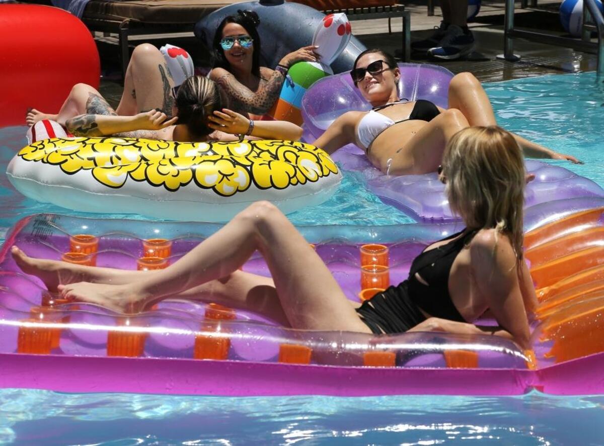 ‘Camming’ models sunbathe in the pool at the SLS South Beach hotel during the Cam Con trade show in Miami Beach. The industry celebrates its fifth anniversary this week on South Beach.