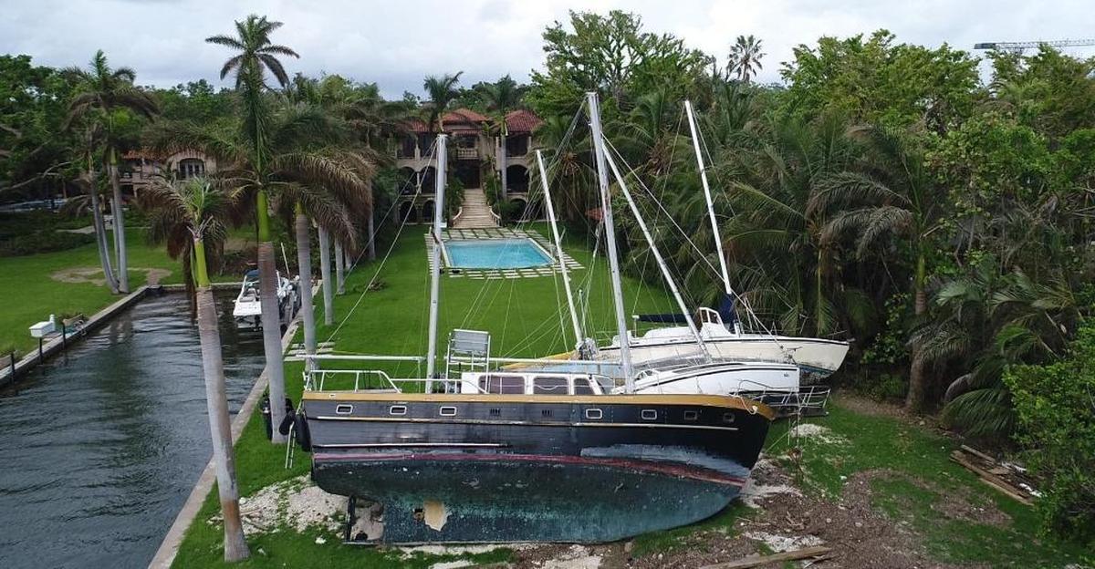 Four sail boats litter the lawn of a mansion in Coconut Grove. The boats were left stranded after strong winds and storm surge from Hurricane Irma pushed them ashore.