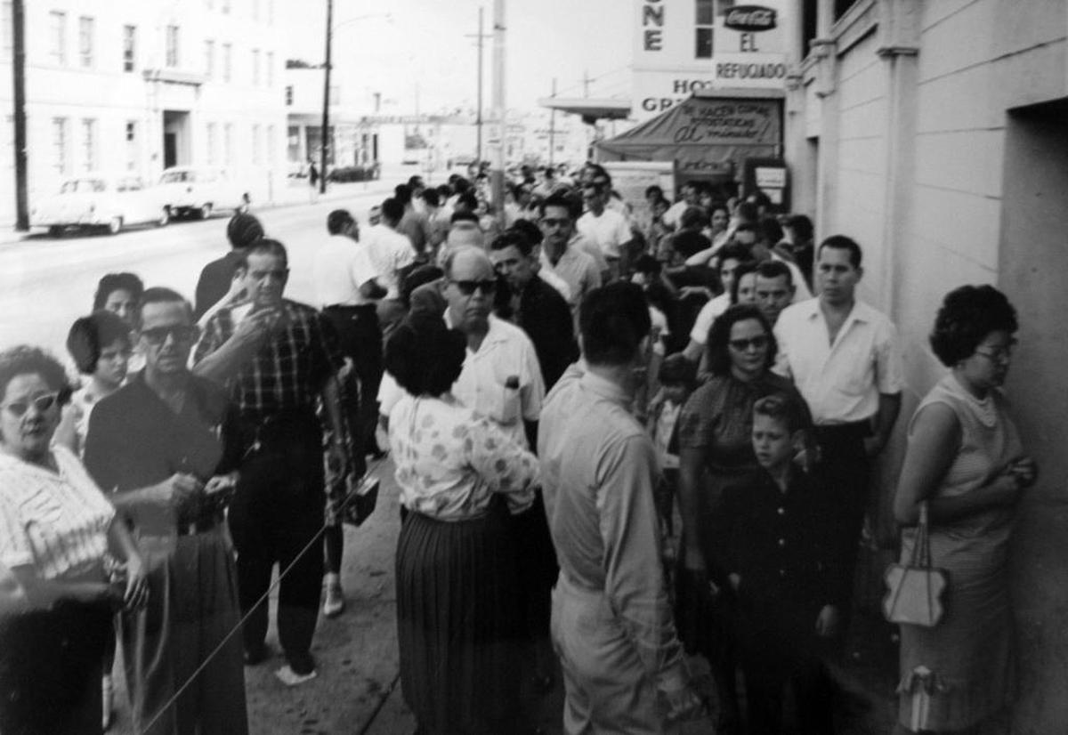 Cuban refugees who arrived in the U.S. on the Freedom Flights in the 1960s stand in line outside the Freedom Tower in downtown Miami, where they received all their services, from food to medical care.