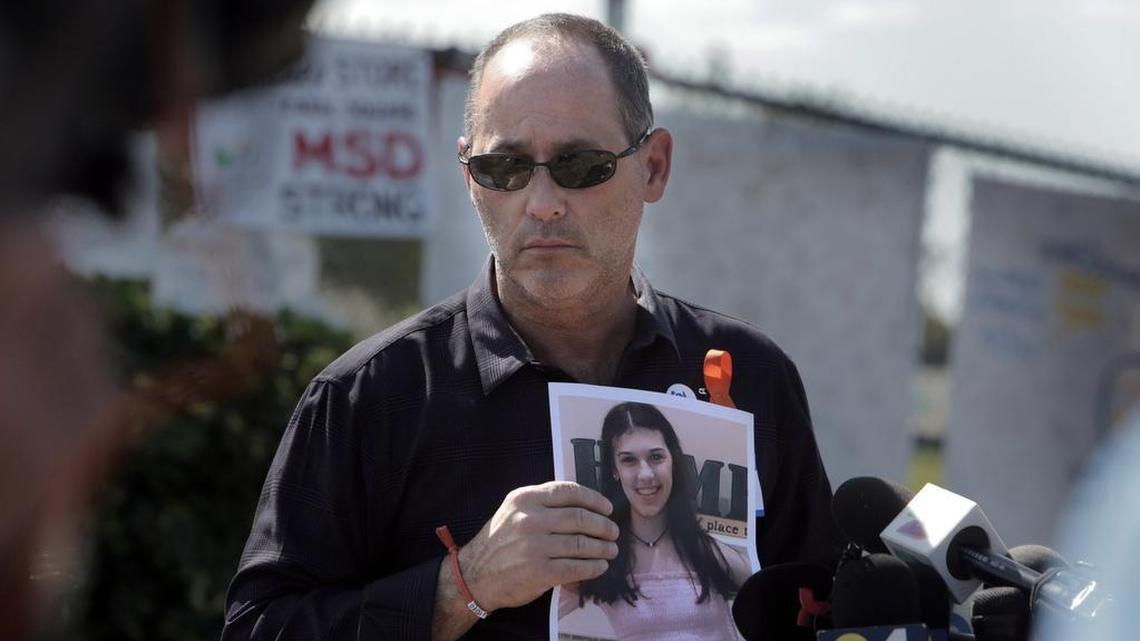 Fred Guttenberg, father of Jaime Guttenberg, who was killed in the Parkland massacre, holds a photo of Jaime as he listens to questions from reporters in front of Marjory Stoneman Douglas High School in March 2018.