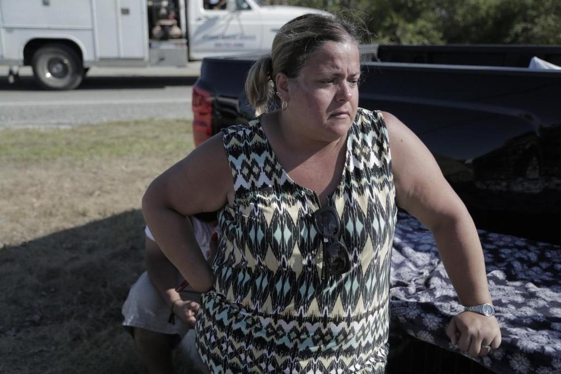 Judith Silva waits for authorities to let her and her family through a roadblocl and to their home on Marathon Key.