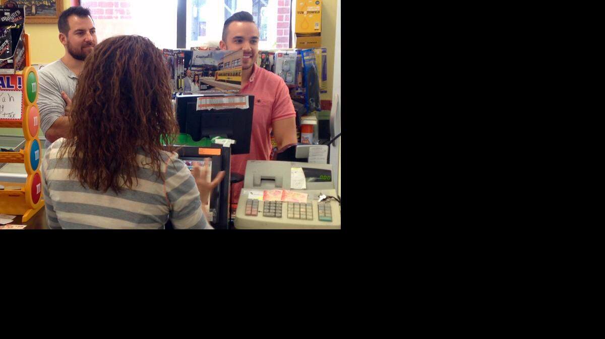 Shane Krugman (left) and Ryan McGuinness purchase powerball tickets in Ybor City. (Josh Rojas, Bay News 9)
