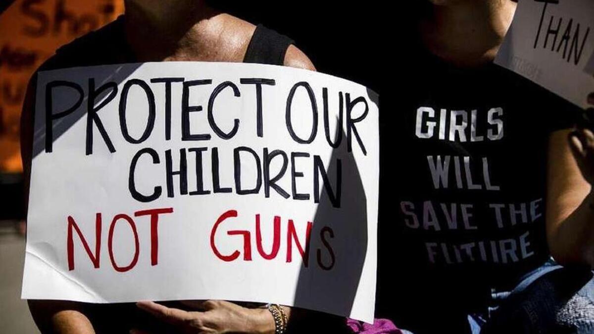 A sign at a rally in favor of new gun legislation outside the federal courthouse in Fort Lauderdale on Saturday.