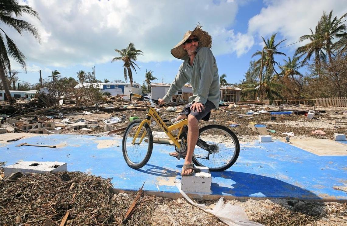 Billy Quinn sits on his bike and the concrete slab where his trailer once stood at the Seabreeze trailer park along the Oversees Highway a day after Hurricane Irma struck the Lower Keys.