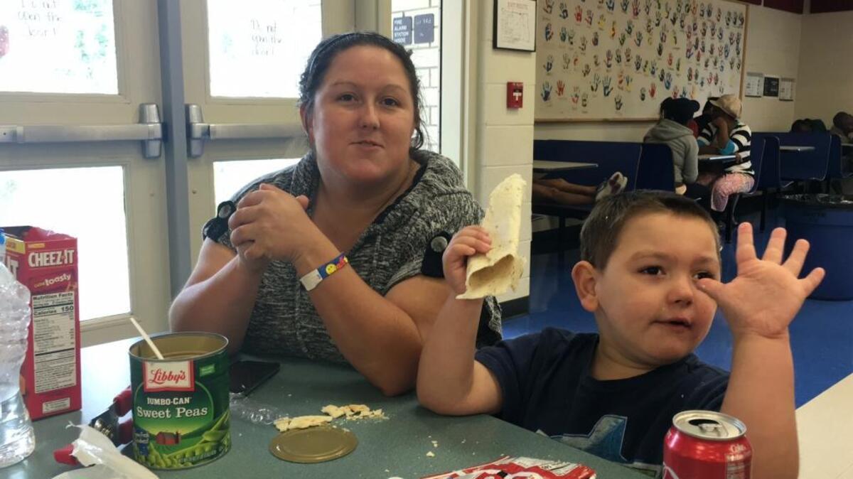 Amanda Meek, left, of Bradenton sat down with her sons, Cameron, 5, and Christopher, 6, not shown, and explained to them why hurricane winds howl so they will be prepared. The family is evacuated to Prine Elementary School, which was approaching 1,000 evacuees by noon Sunday.