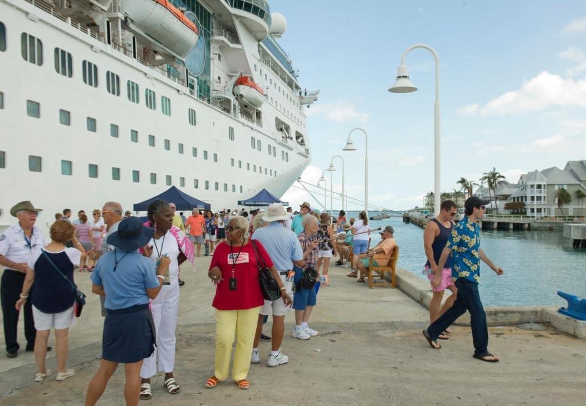 In this photo provided by the Florida Keys News Bureau, passengers from the Empress of the Seas walk on the Pier B cruise ship dock after the ship arrived in Key West, Sunday, Sept. 24, 2017. The ship’s port call was the first by a cruise ship since Hurricane Irma.