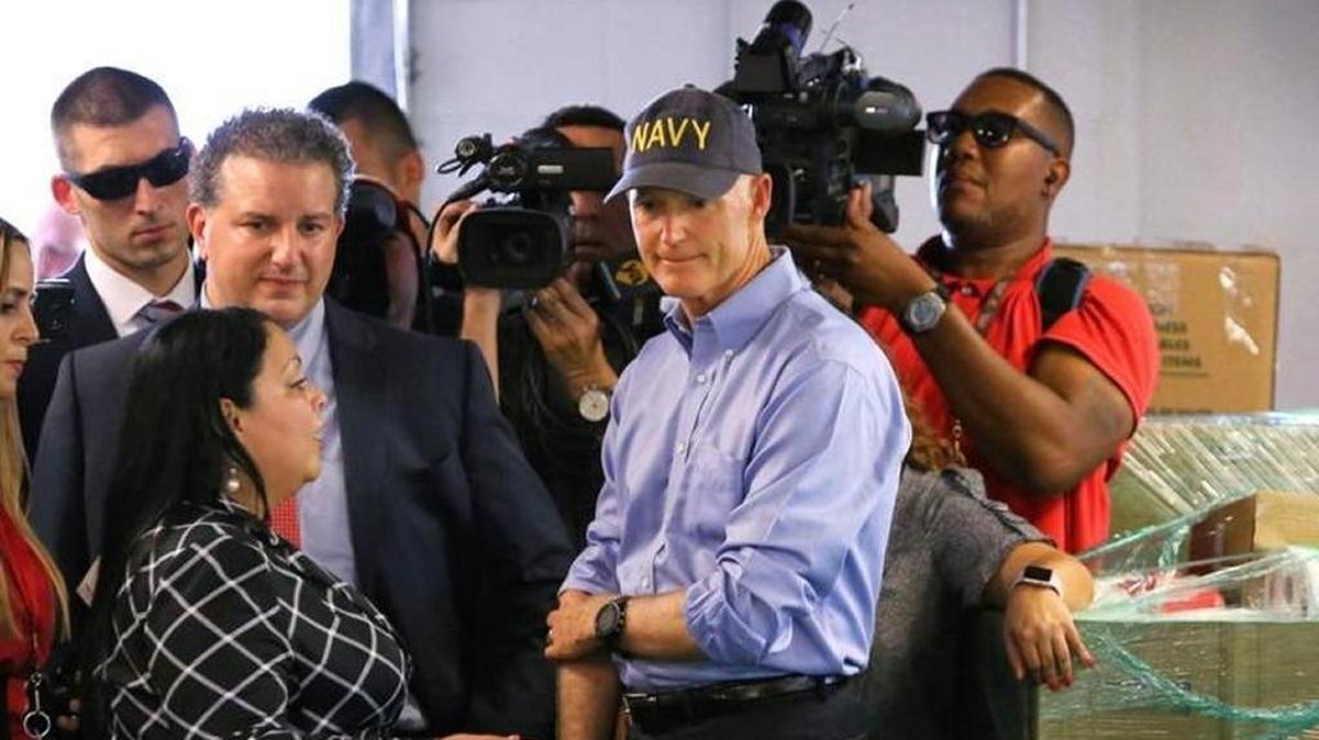 Florida Gov. Rick Scott surveys donated supplies headed to Puerto Rico during a visit with Osceola County volunteers who are assisting with the relief effort for Puerto Rico in the wake of hurricane Maria, in Kissimmee, Wednesday, Sept. 27, 2017.