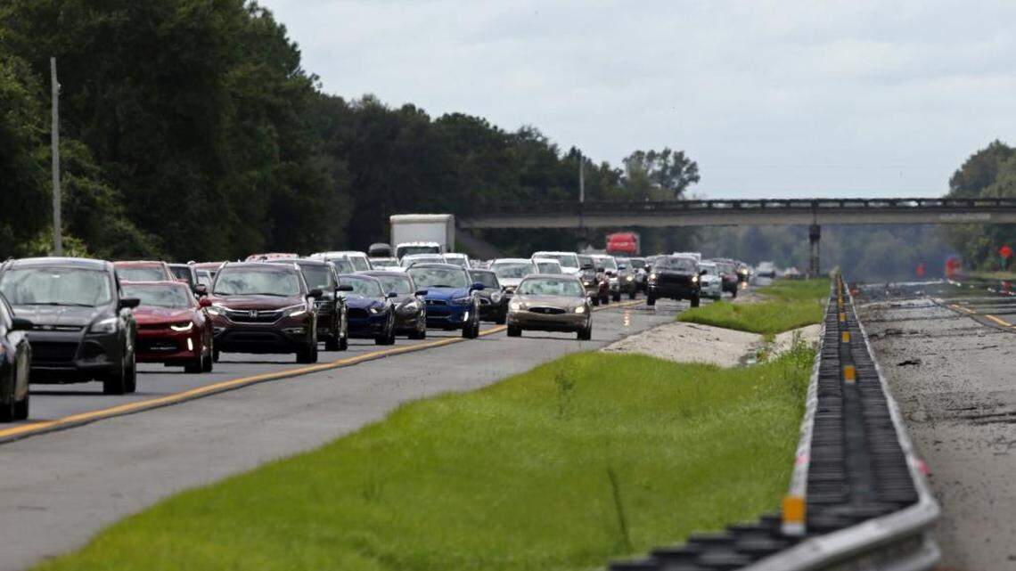 A car rides in the shoulder to pass other cars in evacuation traffic on I-75 N, near Brooksville, Fla., in advance of Hurricane Irma, Saturday, Sept, 9, 2017. With the window closing fast for anyone wanting to escape, Irma hurtled toward Florida with 125 mph winds Saturday on a projected track that could take it away from Miami and instead give the Tampa area its first direct hit from a major hurricane in nearly a century.