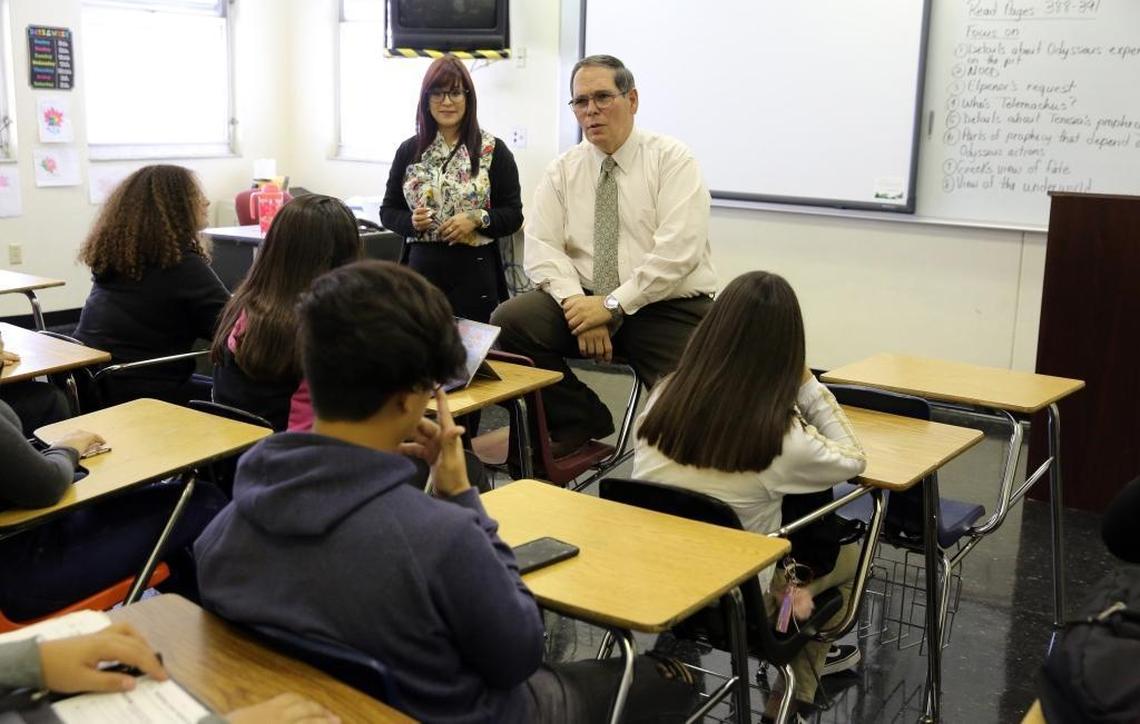 Joanyri Hernandez, 40, and Barbara Goleman Senior High Principal, Joaquin Hernandez, talk to Joanyri's ninth-grade students about ‘The Odyssey’ during class Tuesday, Nov. 28, 2017.