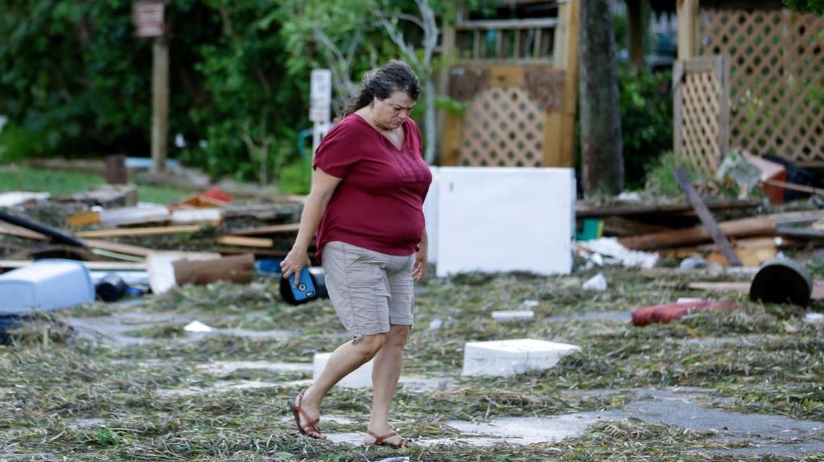 A resident checks on damage from Hurricane Hermine Friday, Sept. 2, 2016, in Cedar Key, Fla. Hermine was downgraded to a tropical storm after it made landfall.