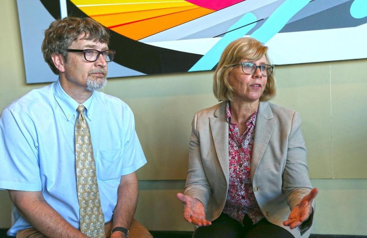 Henry Walke, Chief of the Bacterial Special Pathogens Branch for the Centers for Disease Control and Prevention, and Carmen Deseda, the state epidemiologist for Puerto Rico, discuss public health concerns at the emergency operations center in San Juan.