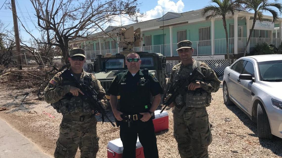 U.S. Army National Guard soldier Pfc. Fabio Saldanha, Monroe County Sheriff’s Office Deputy David Brummer and Pvt. Nicholas Redler stand guard at a checkpoint set up at the entrance of Spanish Main Drive on Cudjoe Key Sunday, Sept. 17.