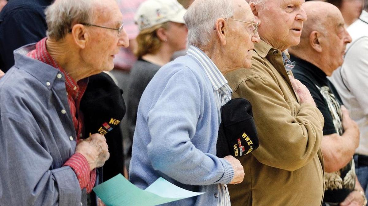 Veterans Carroll Southards, Charles Veal, Floyd Johnson, and John Steine recite the "Pledge of Allegiance" along with visitors and students during a Veterans Day ceremony Thursday in Maryville, Tenn.