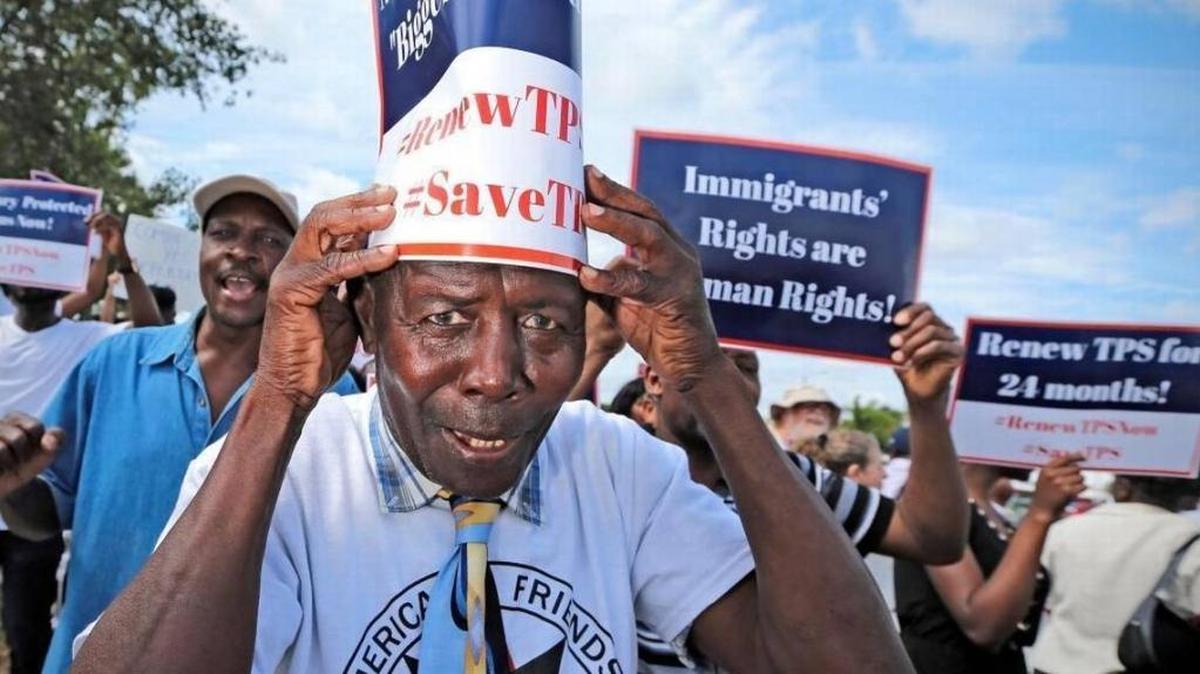 FILE: Jean Claude Akkawy Damus joins Haitian and immigration advocates at a rally demanding the Trump administration extend Temporary Protected Status for Haitians as they march at the U.S. Citizenship and Immigration Services Miami office in May.