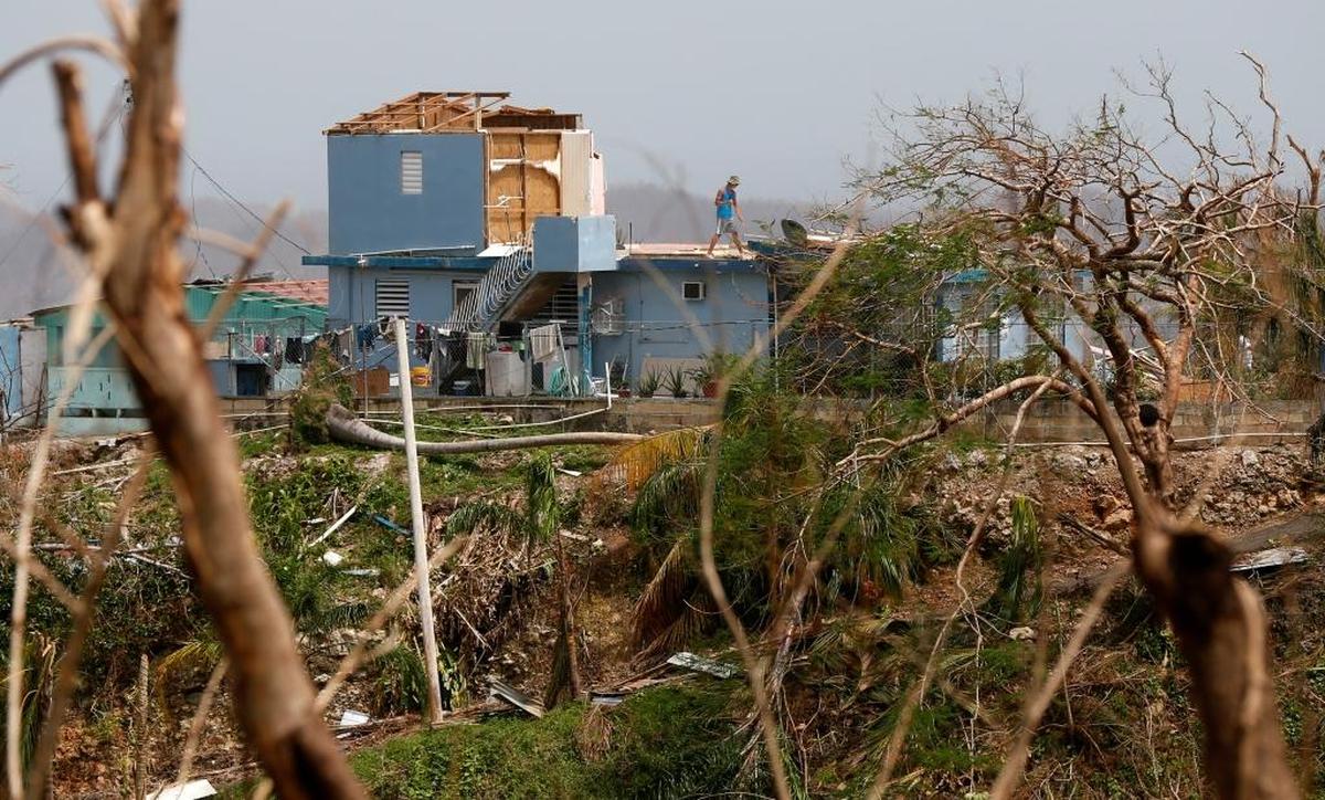 A man sweeps his heavily damaged home in Montebello, Puerto Rico, in the aftermath of Hurricane Maria, Tuesday, Sept. 26, 2017. Five days after the Category 4 storm slammed into Puerto Rico, many of the more than 3.4 million U.S. citizens in the territory were still without adequate food, water and fuel. Flights off the island were infrequent, communications were spotty and roads were clogged with debris. Officials said electrical power may not be fully restored for more than a month.