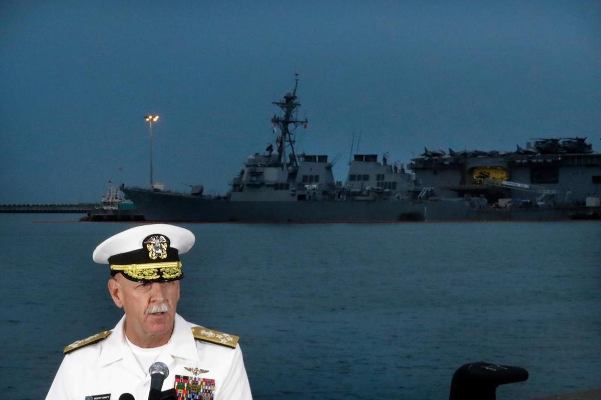 Commander of the U.S. Pacific Fleet, Scott Swift answers questions during a press conference with the USS John S. McCain and USS America docked in the background at Singapore's Changi naval base on Tuesday, Aug. 22, 2017 in Singapore.