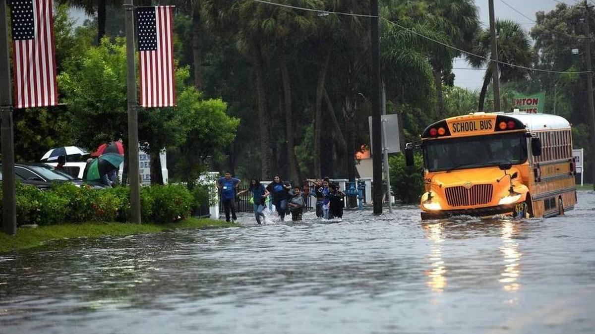 File photo: Tropical storm Hermine’s approaching rain bands turned Bradenton roads into a series of flooded areas. Schoolchildren wave and run alongside their bus as it travels down a flooded U.S. 41.
