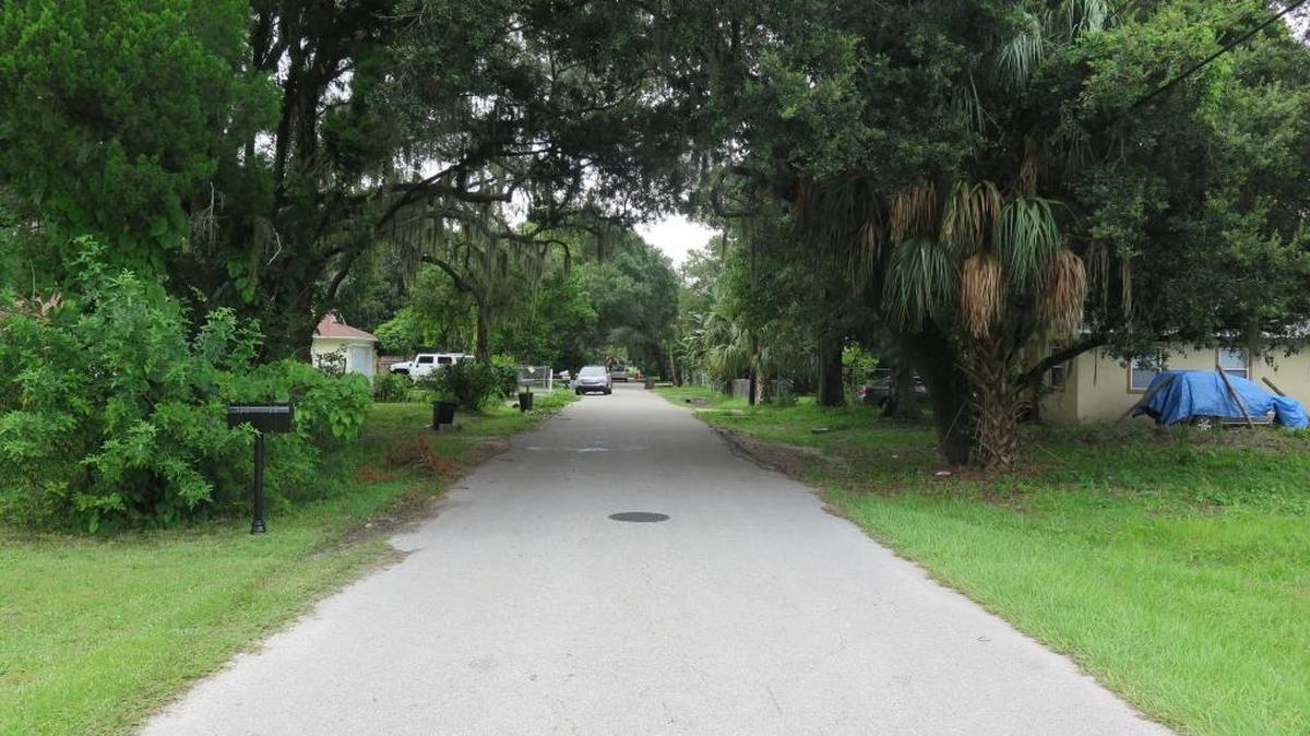 A part of Samoset resident Taura Denis’ street is darkened by towering trees. A group of residents are petitioning for the installment of street lighting.