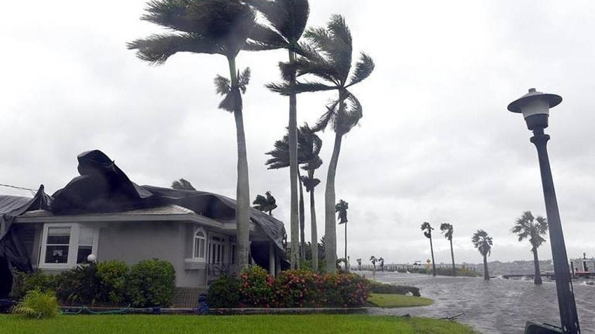 A tarp whips in the wind on a home on Riverview Blvd. as Tropical Storm Emily passed through the area Monday morning.
