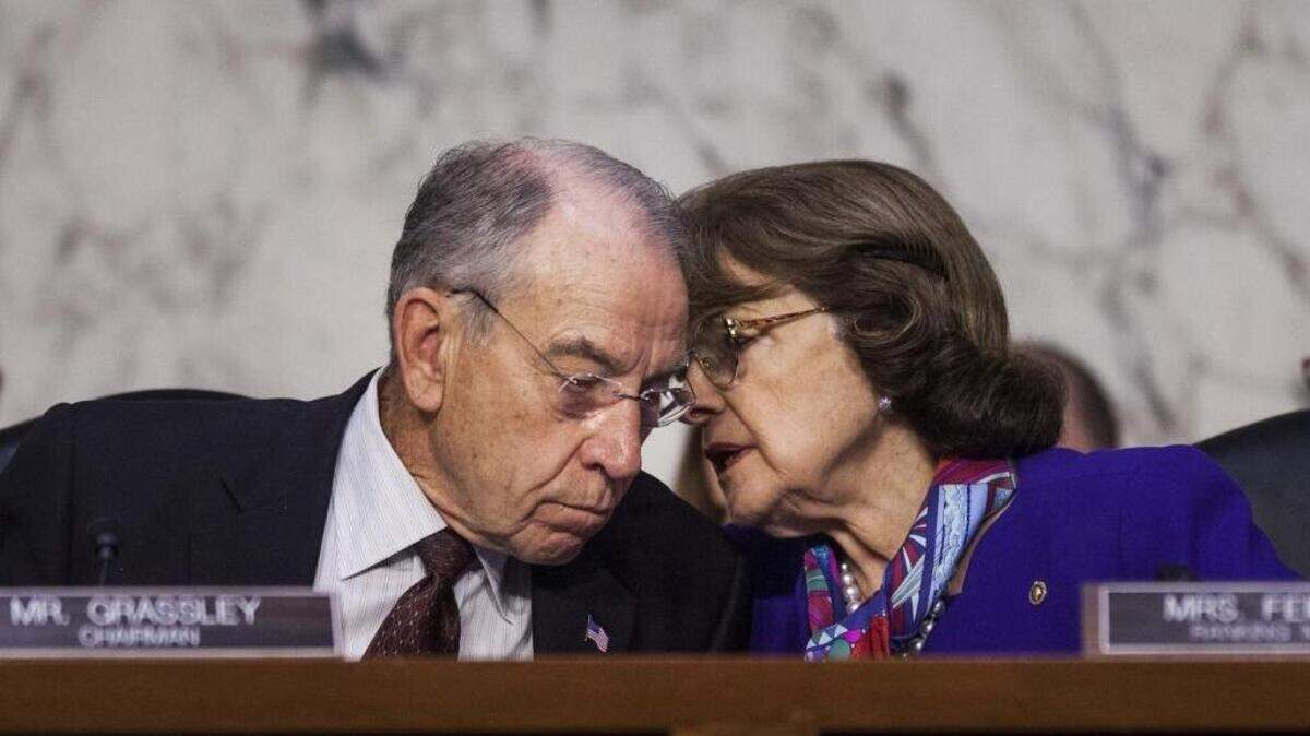 Sen. Charles E. Grassley, R-Iowa, and Sen. Dianne Feinstein, D-Calif., confer during a hearing on Oct. 18, 2017.