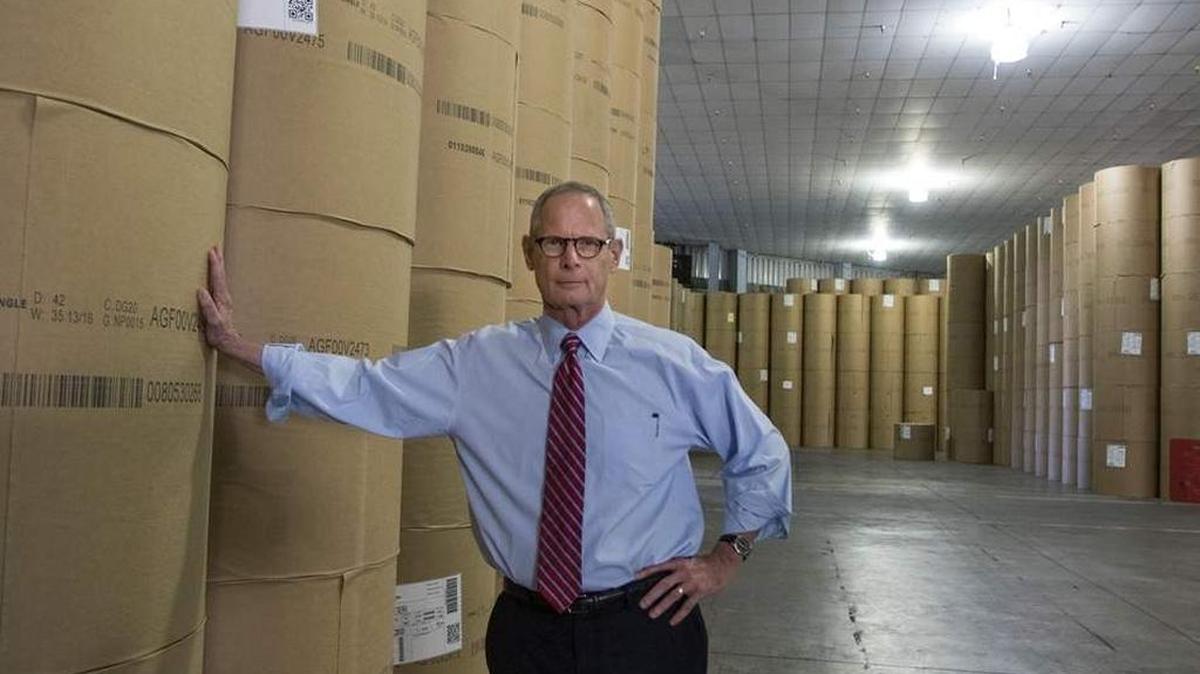 Paul Tash, chairman and CEO of Times Publishing Company, stands next to rolls of newsprint at the Tampa Bay Times printing plant.
