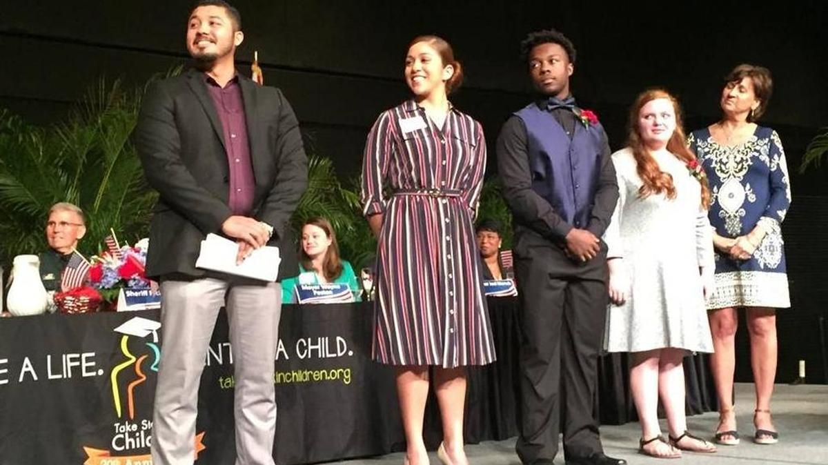 Take Stock in Children scholars Emanuel Leon, Jennifer Caba, Kevin Townsend, Alexis Vaughn and mentor Paulette Gandel on stage Jan. 26, 2017 at the 10th Annual Take Stock in Children Leadership Prayer Breakfast at the Bradenton Area Convention Center.
